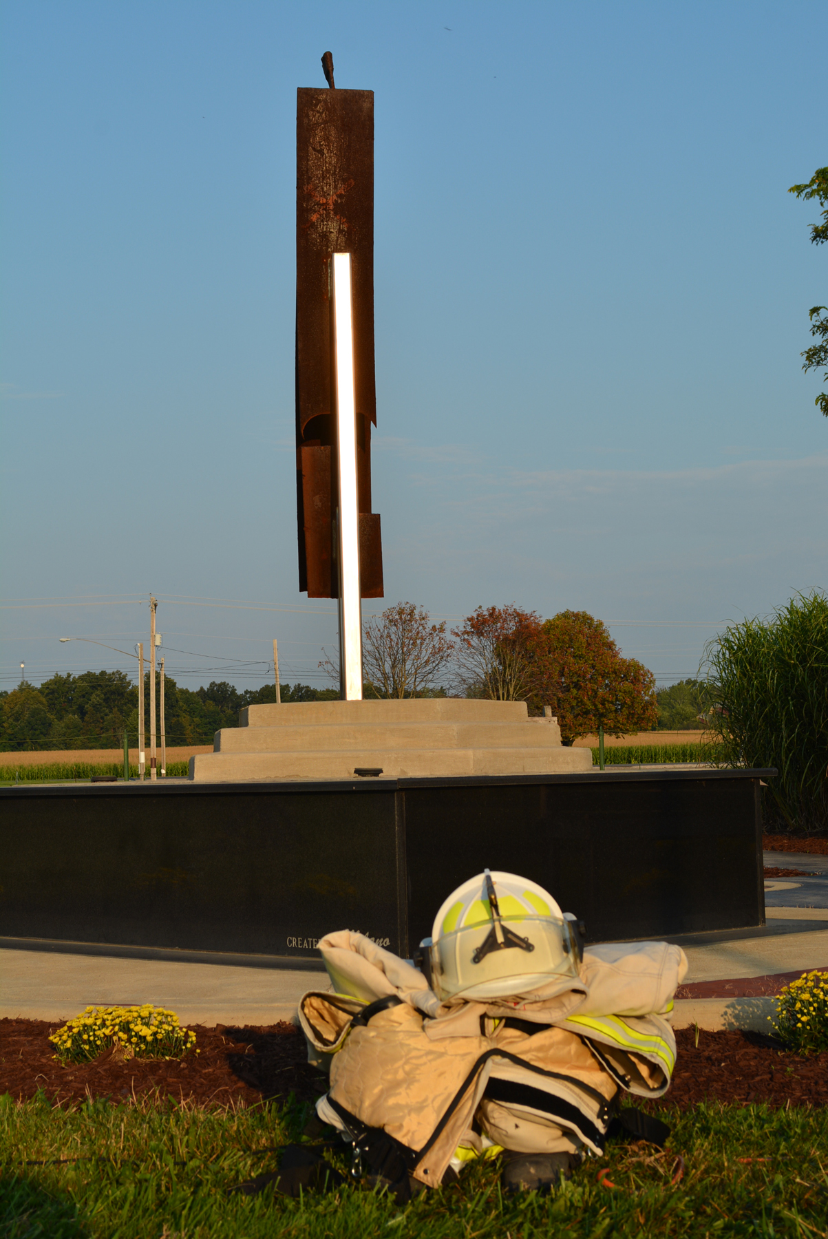 9-11 Memorial with firefighter gear and helmet at the base